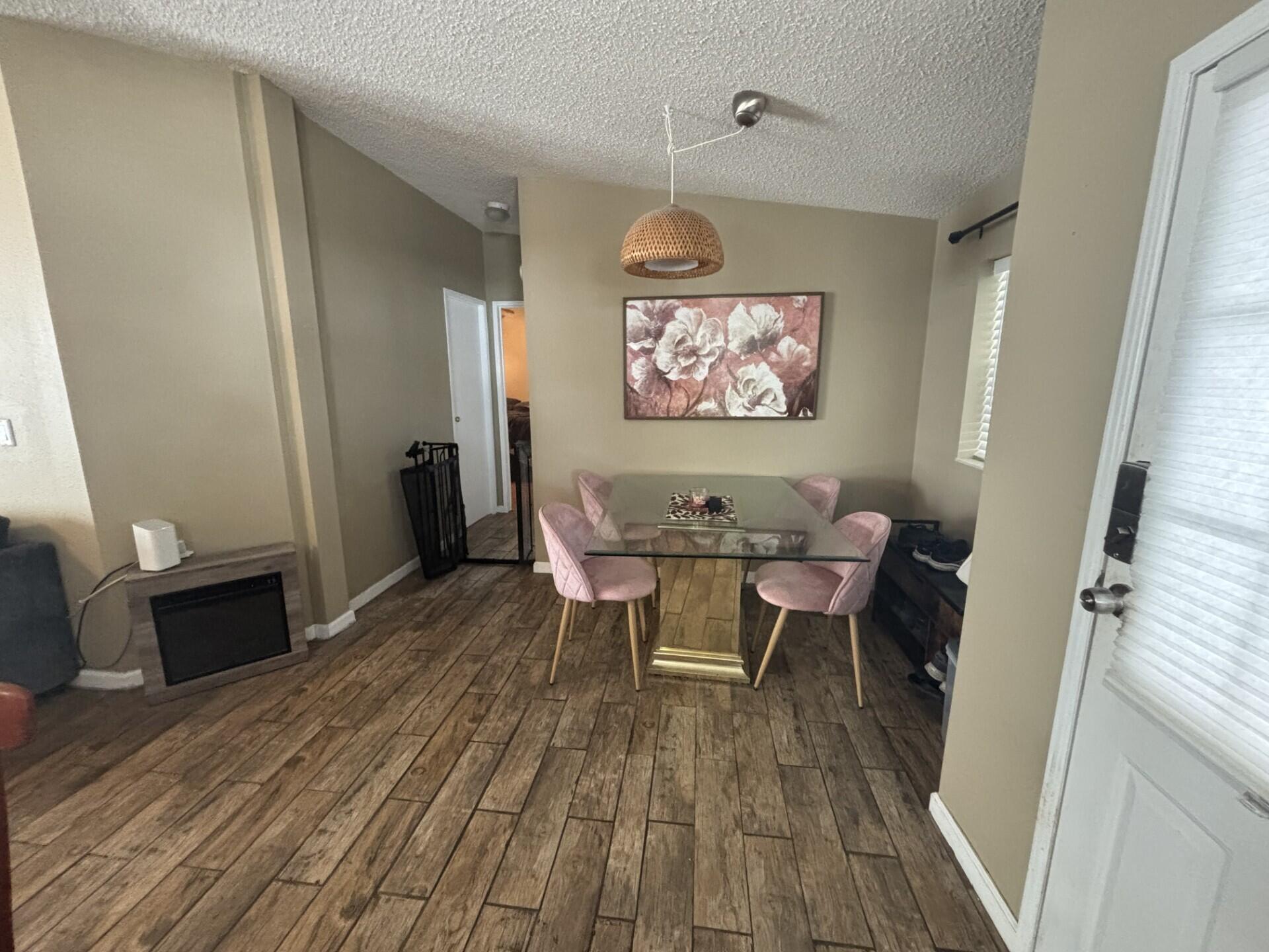6567 Northwest 34th Avenue Pompano Beach, FL 33073 - Photo 16 of 30 a view of a dining room with furniture wooden floor and a rug