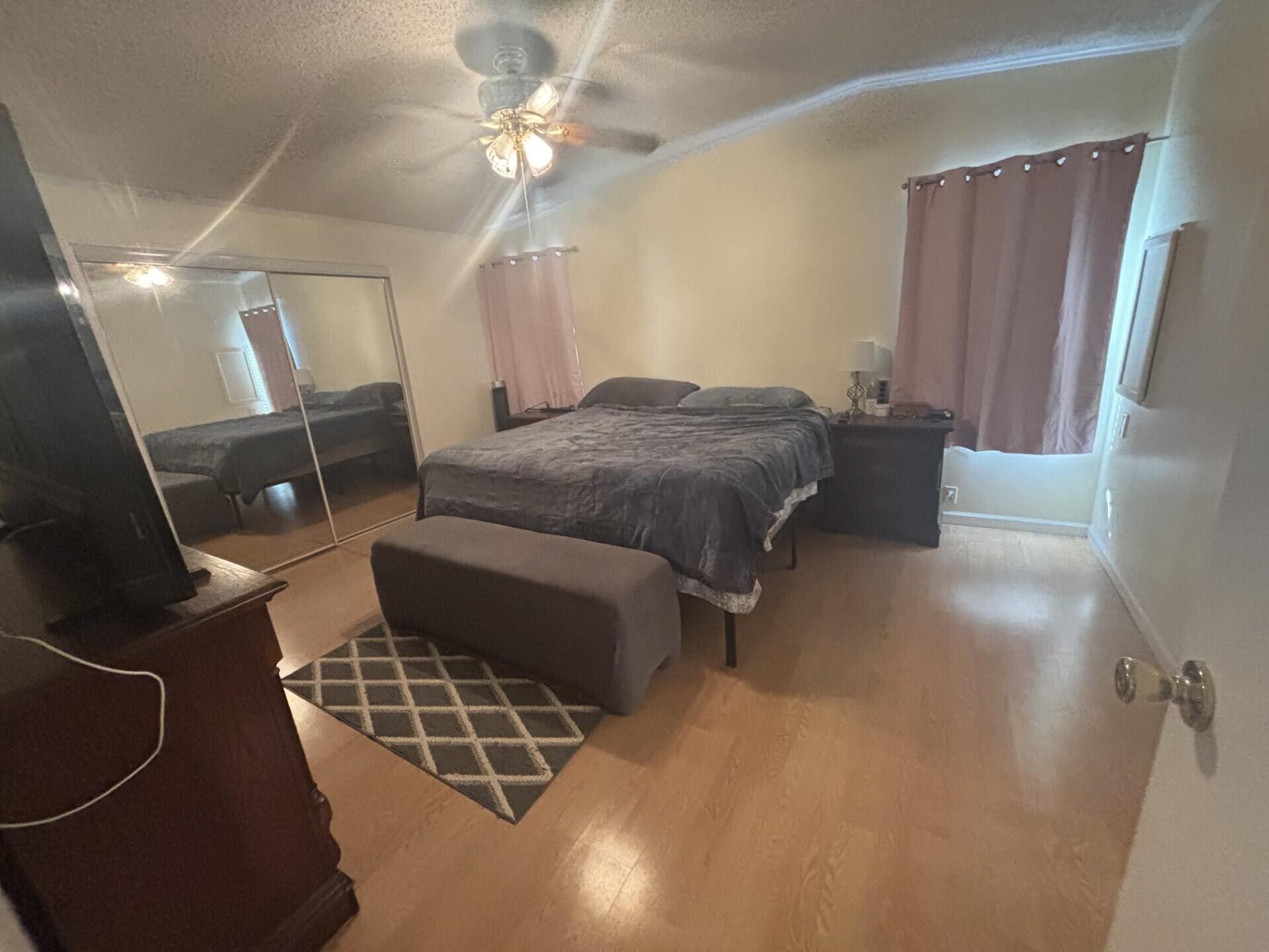 6567 Northwest 34th Avenue Pompano Beach, FL 33073 - Photo 17 of 30 a spacious bedroom with a bed and a chandelier