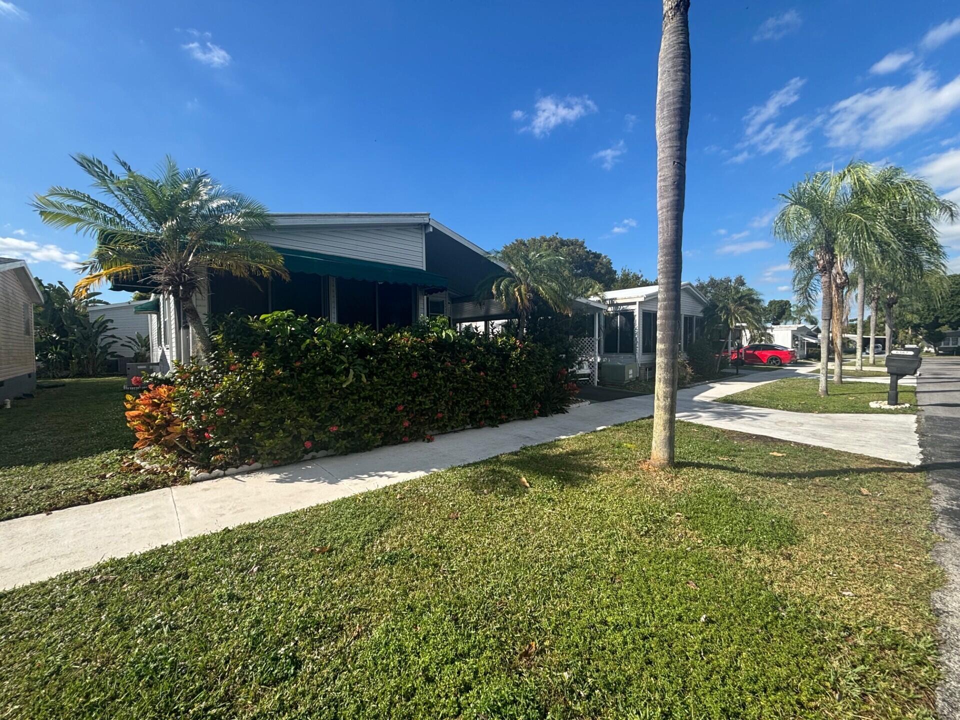 6567 Northwest 34th Avenue Pompano Beach, FL 33073 - Photo 2 of 30 a view of a garden with a tree