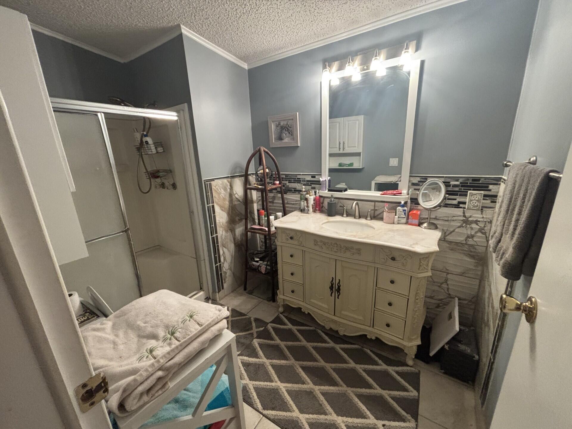 6567 Northwest 34th Avenue Pompano Beach, FL 33073 - Photo 21 of 30 a bathroom with a double vanity sink mirror and toilet
