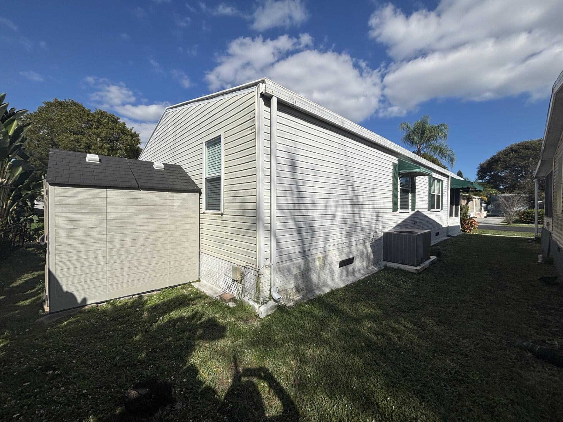 6567 Northwest 34th Avenue Pompano Beach, FL 33073 - Photo 29 of 30 a backyard of a house with lots of green space