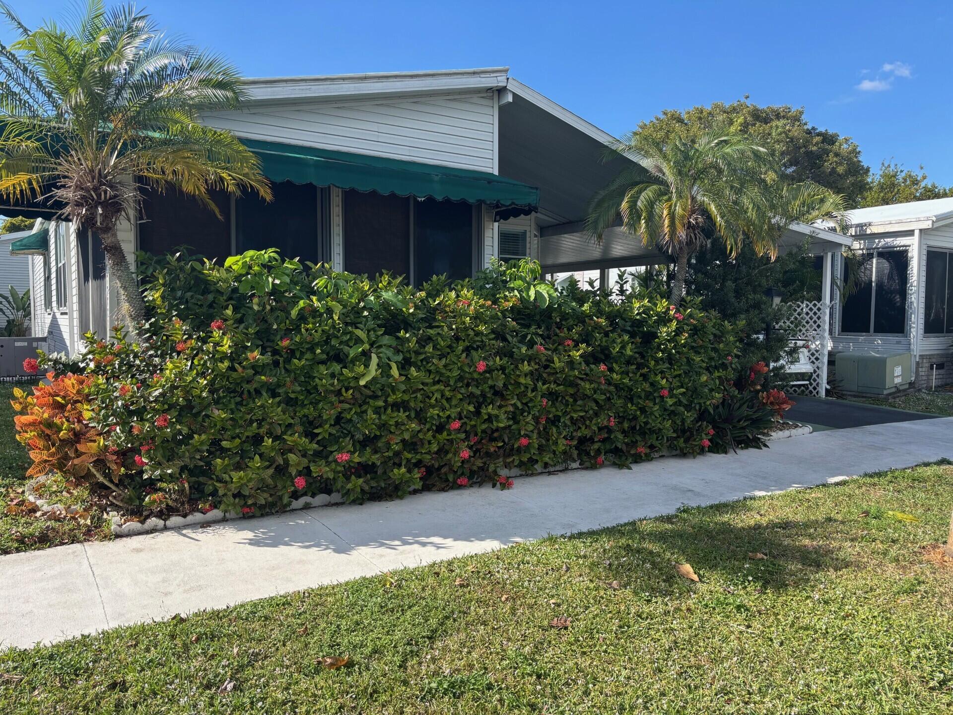 6567 Northwest 34th Avenue Pompano Beach, FL 33073 - Photo 3 of 30 a view of a house with potted plants