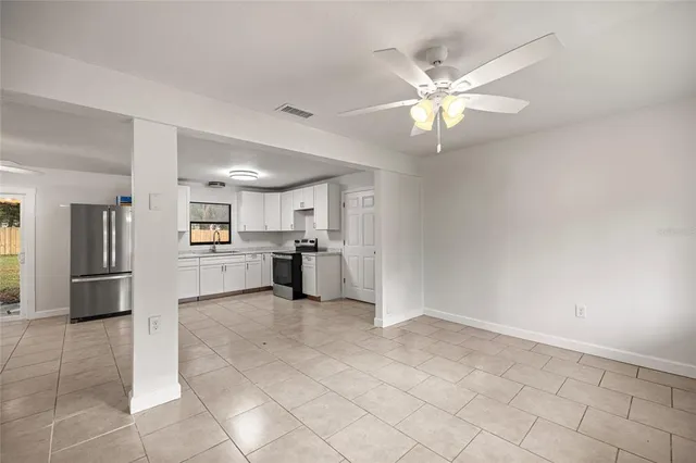 a view of kitchen with refrigerator and window