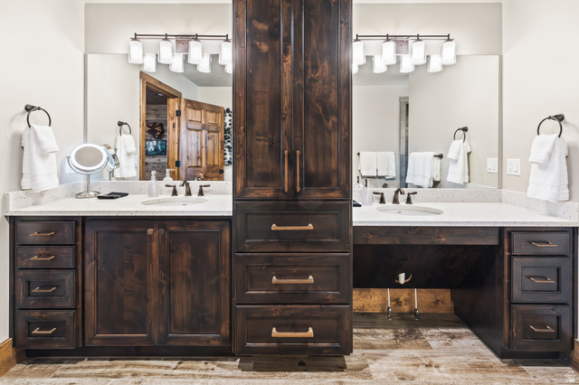 2031 South Quakie Road Koosharem, UT 84744 - Photo 19 of 33 Dual vanity with light-toned countertops, integrated sinks, dark wood-finish cabinetry, and a central storage tower