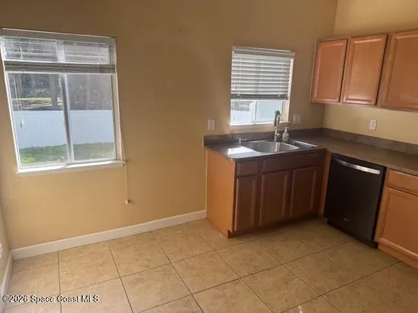 a kitchen with stainless steel appliances granite countertop a refrigerator stove and microwave