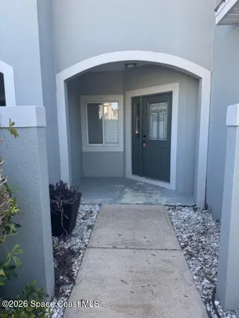 a view of a hallway that has two windows and a rug