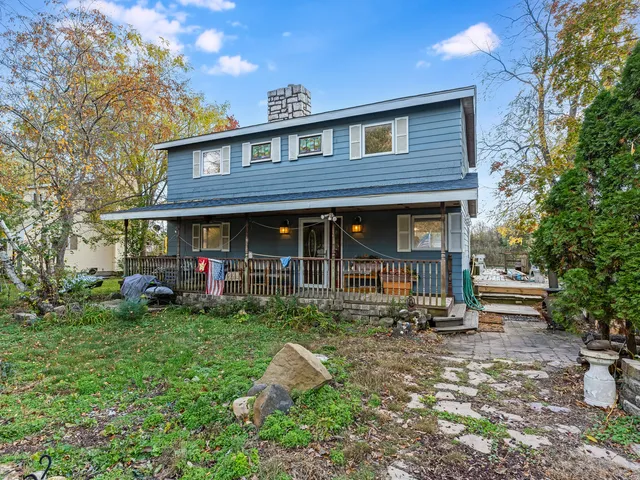 a front view of a house with garden and porch