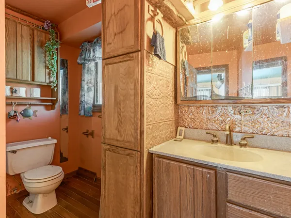 a bedroom with a bed dresser and a large window