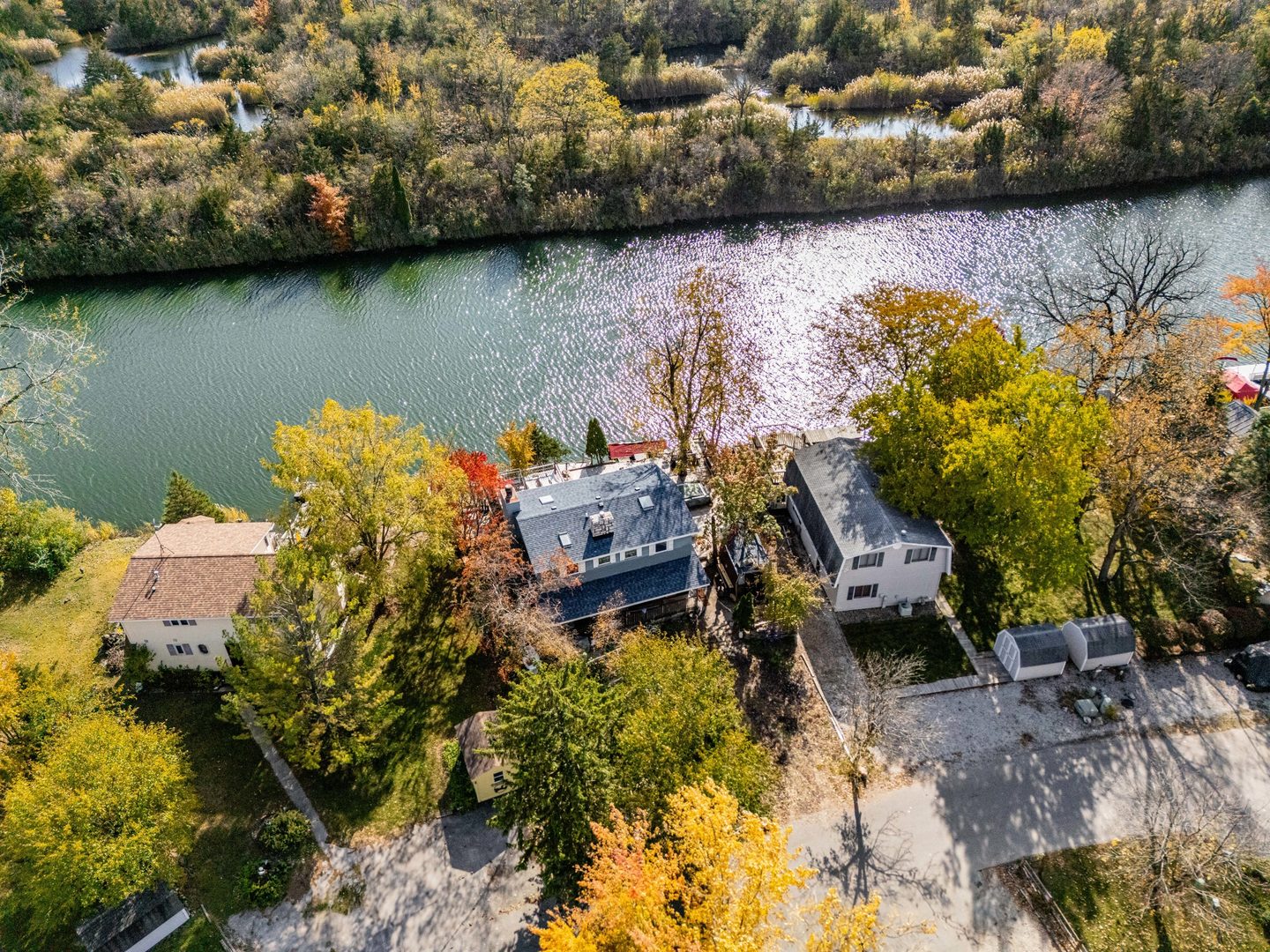 72 Largemouth Lane Wilmington, IL 60481 - Photo 2 of 34 a view of a lake with lawn chairs and large trees