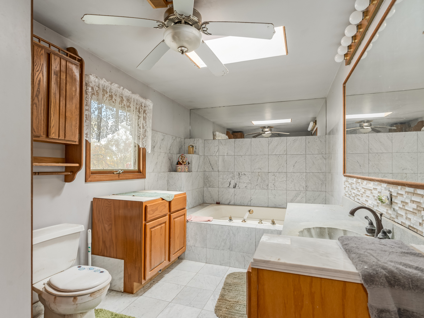72 Largemouth Lane Wilmington, IL 60481 - Photo 21 of 34 a bathroom with a granite countertop sink mirror bathtub and toilet