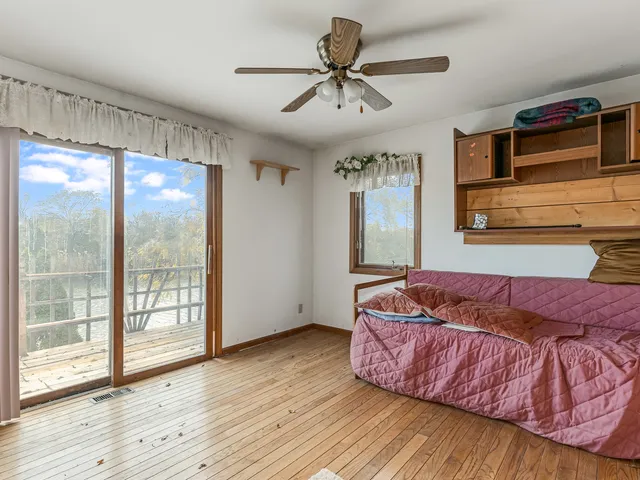 an aerial view of a house with a garden and lake view