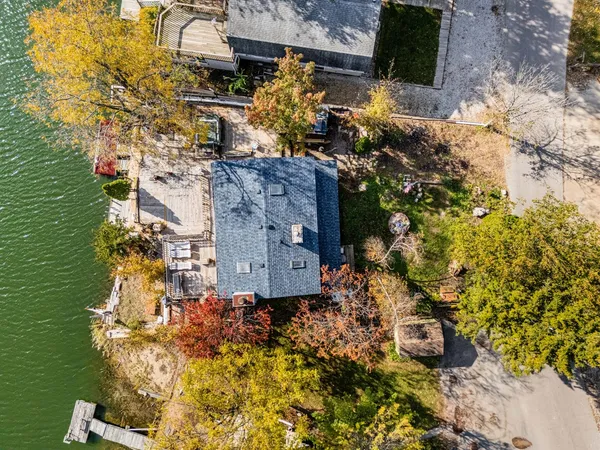 an aerial view of a house with a yard lake view