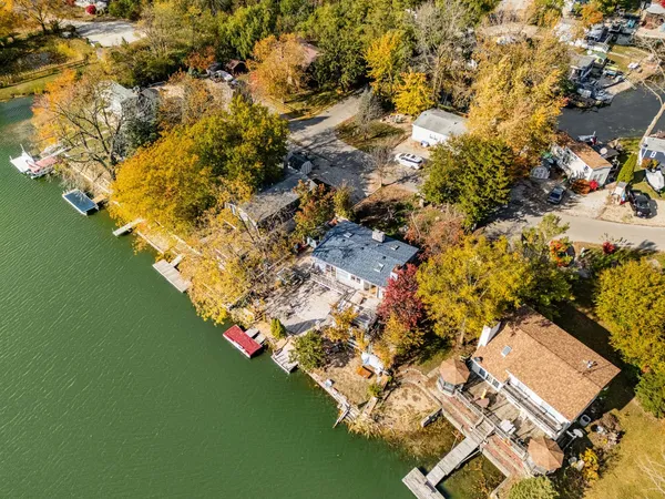 an aerial view of a house with a yard basket ball court and outdoor seating