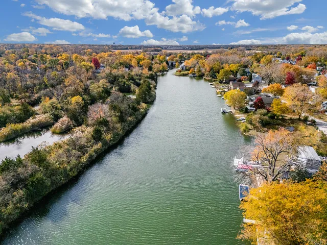 an aerial view of a house with a lake view