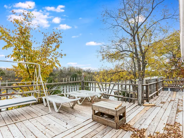 a view of a roof deck with couches and wooden floor