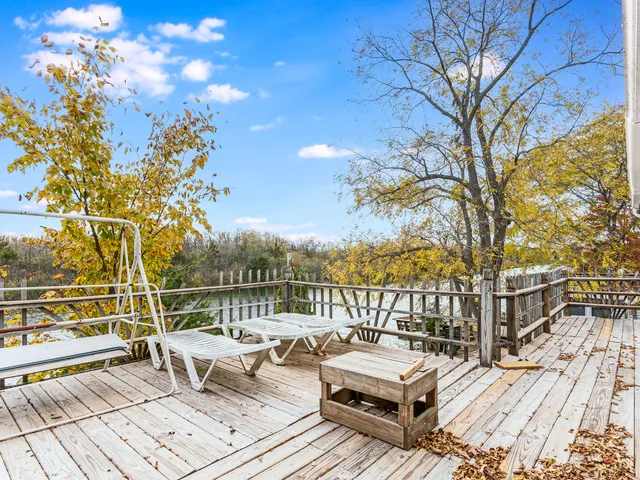 a view of a roof deck with couches and wooden floor
