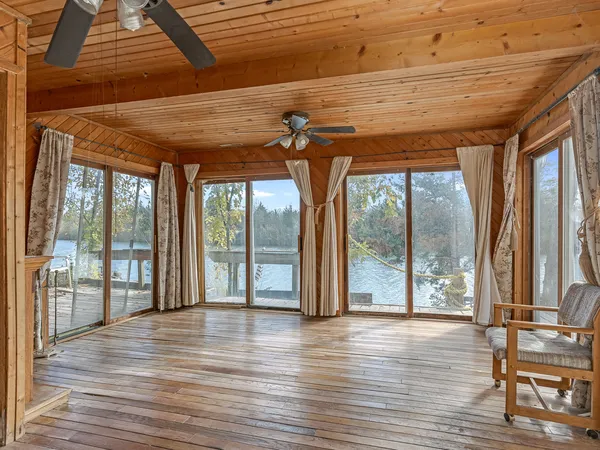 a view of a room with wooden floor and a large window