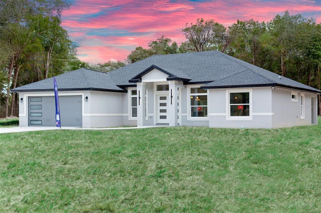 16645 Southwest 59th Court Road Ocala, FL 34473 - Photo 2 of 16 a view of a house with yard and a garden