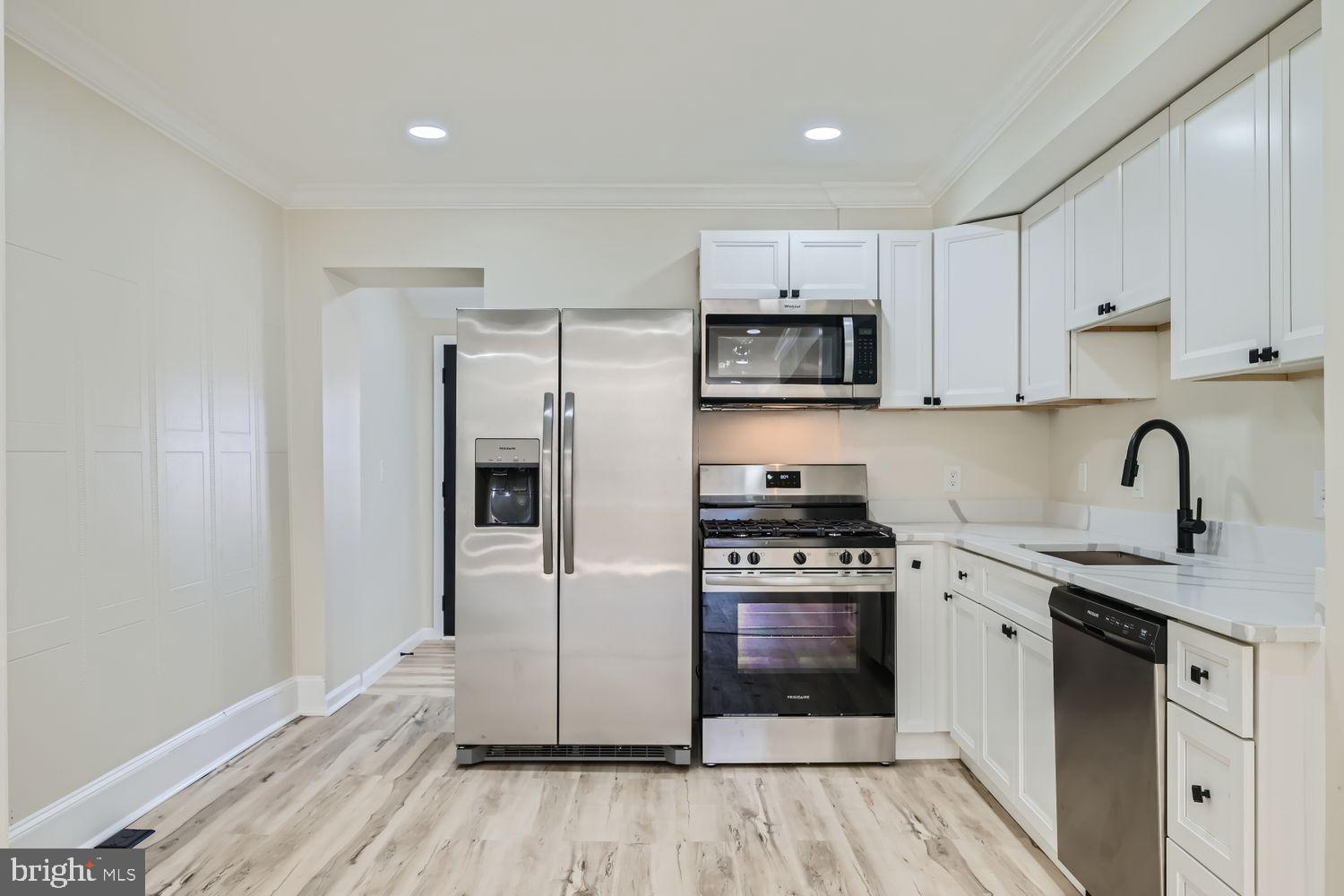 1147 Scott Street Baltimore, MD 21230 - Photo 11 of 28 a kitchen with a sink a stove and refrigerator