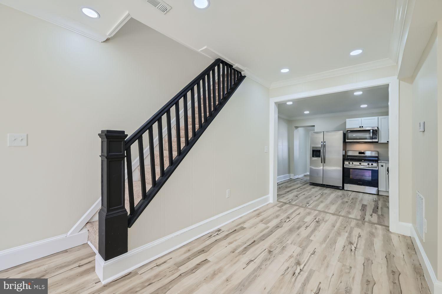 1147 Scott Street Baltimore, MD 21230 - Photo 7 of 28 a view of a hallway with wooden floor and staircase