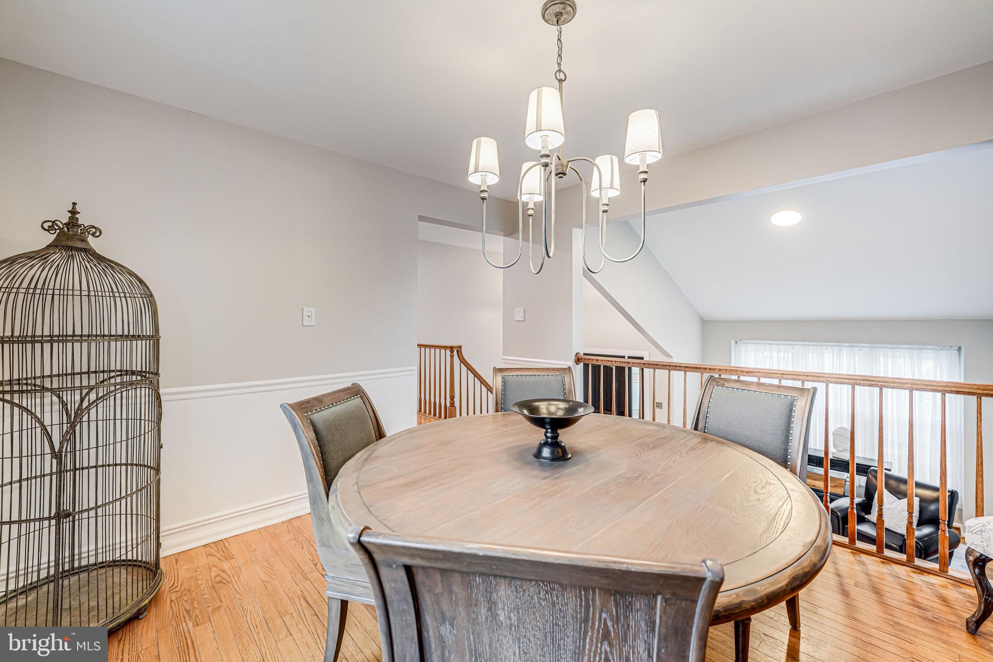107 Country Road Sterling, VA 20165 - Photo 11 of 58 a view of a dining room with furniture and wooden floor