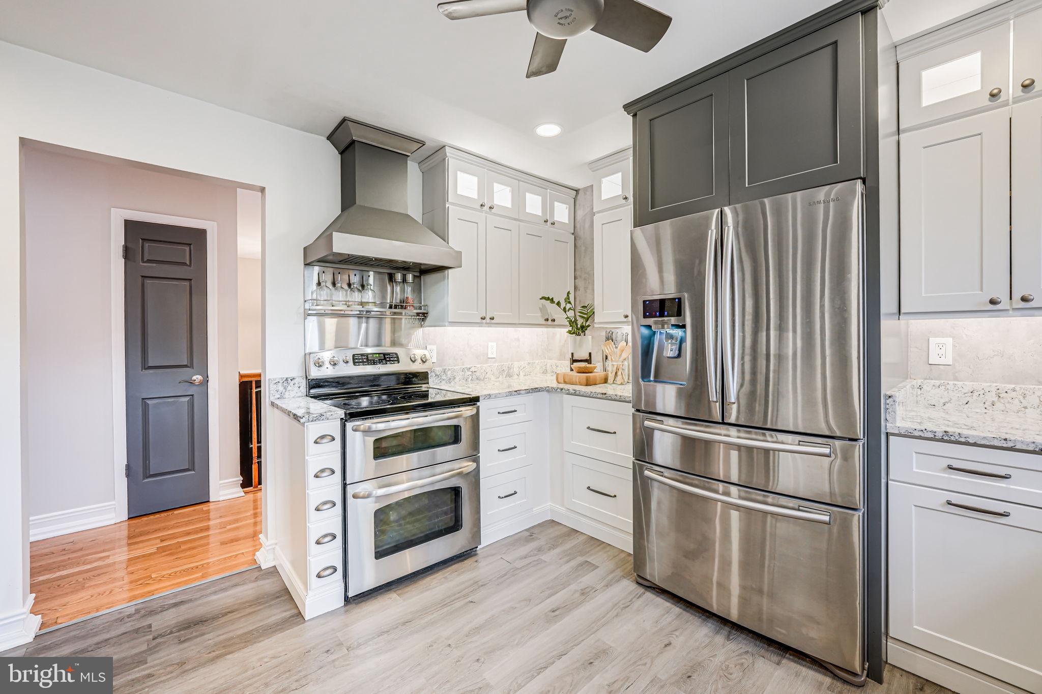 107 Country Road Sterling, VA 20165 - Photo 14 of 58 a kitchen with stainless steel appliances a refrigerator stove and microwave