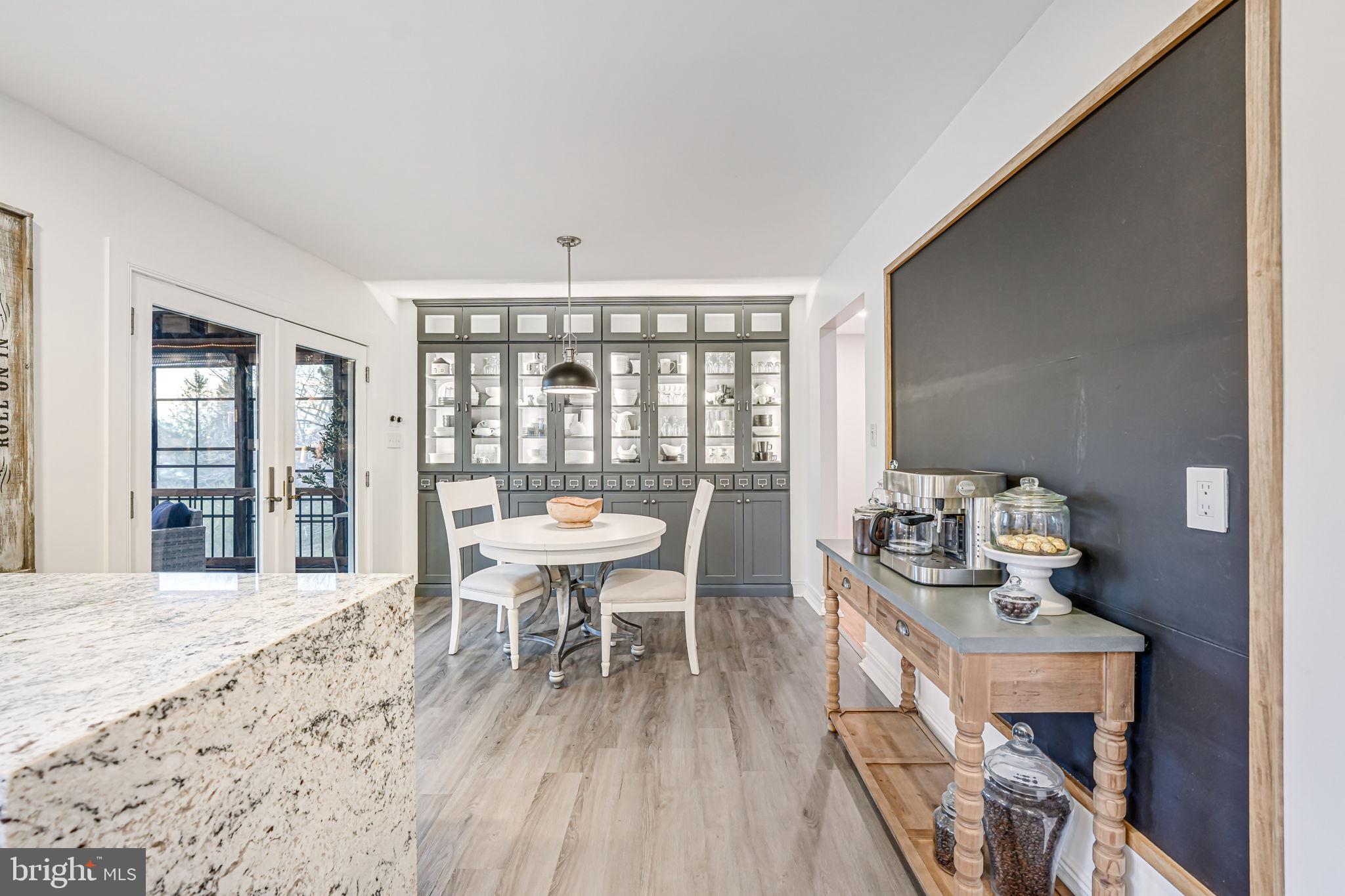 107 Country Road Sterling, VA 20165 - Photo 18 of 58 a dining room with furniture a chandelier and wooden floor