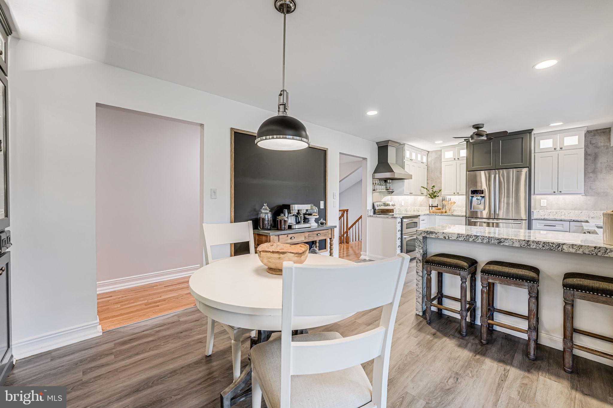 107 Country Road Sterling, VA 20165 - Photo 20 of 58 a kitchen with a table chairs sink and cabinets