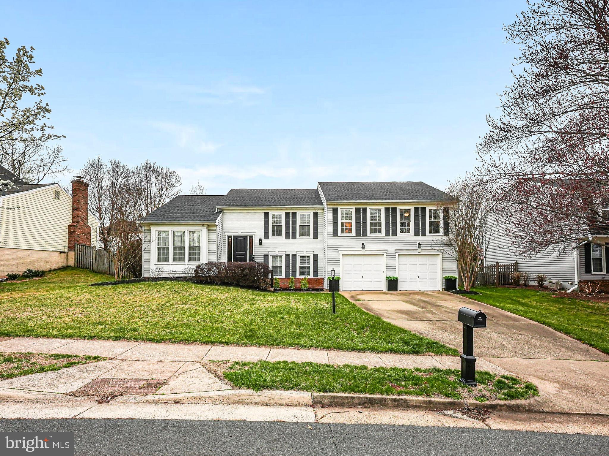 107 Country Road Sterling, VA 20165 - Photo 2 of 58 a front view of a house with a yard