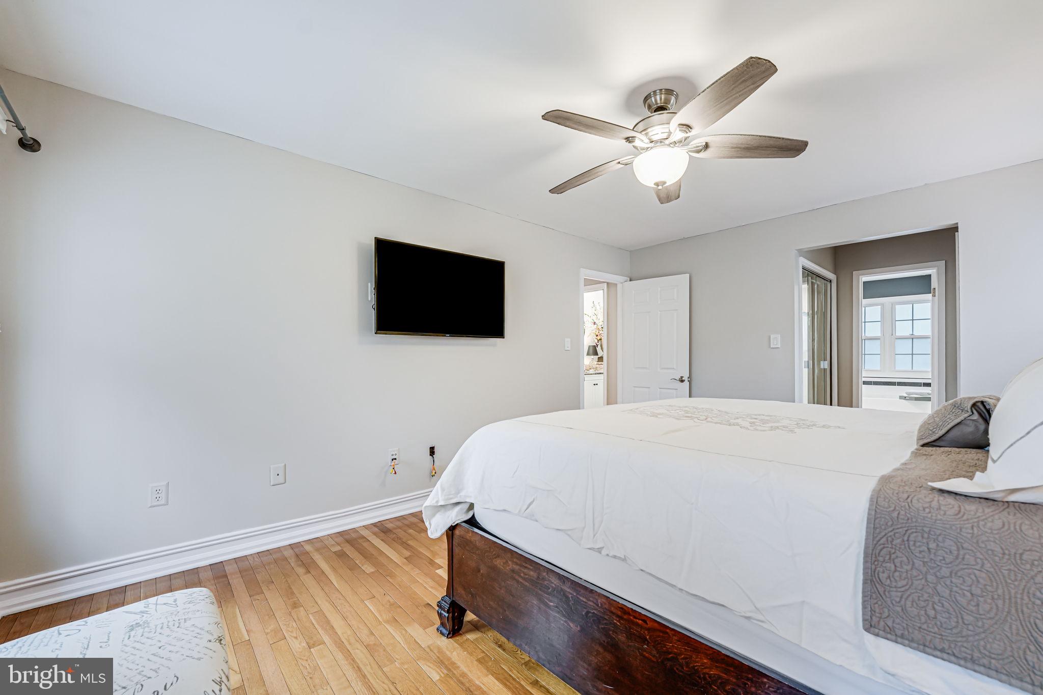 107 Country Road Sterling, VA 20165 - Photo 24 of 58 a bedroom with a bed and a flat screen tv
