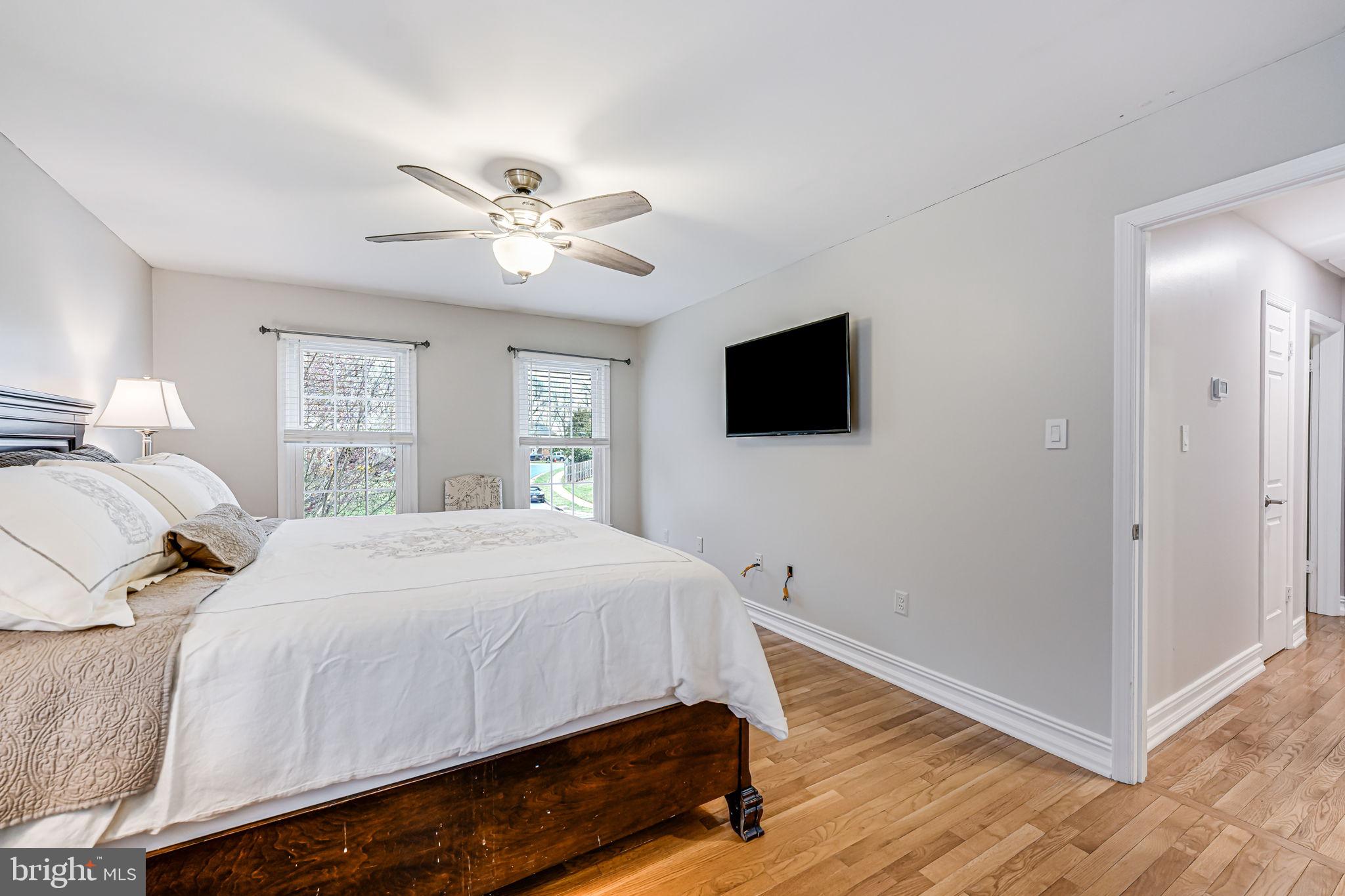 107 Country Road Sterling, VA 20165 - Photo 25 of 58 a bedroom with a bed and a flat screen tv