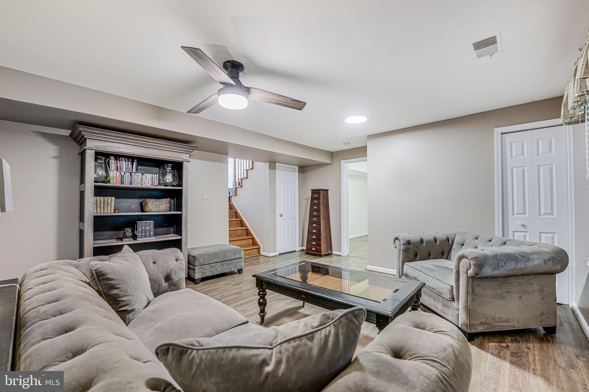 107 Country Road Sterling, VA 20165 - Photo 36 of 58 a living room with furniture and a wooden floor
