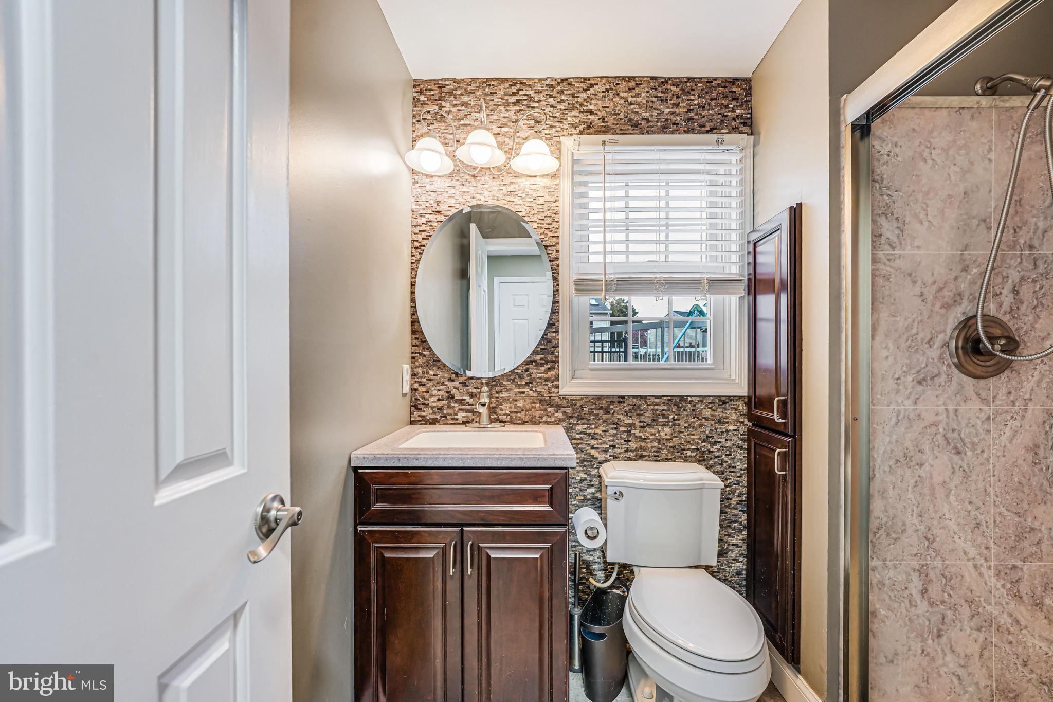 107 Country Road Sterling, VA 20165 - Photo 39 of 58 a bathroom with a toilet a sink and a mirror