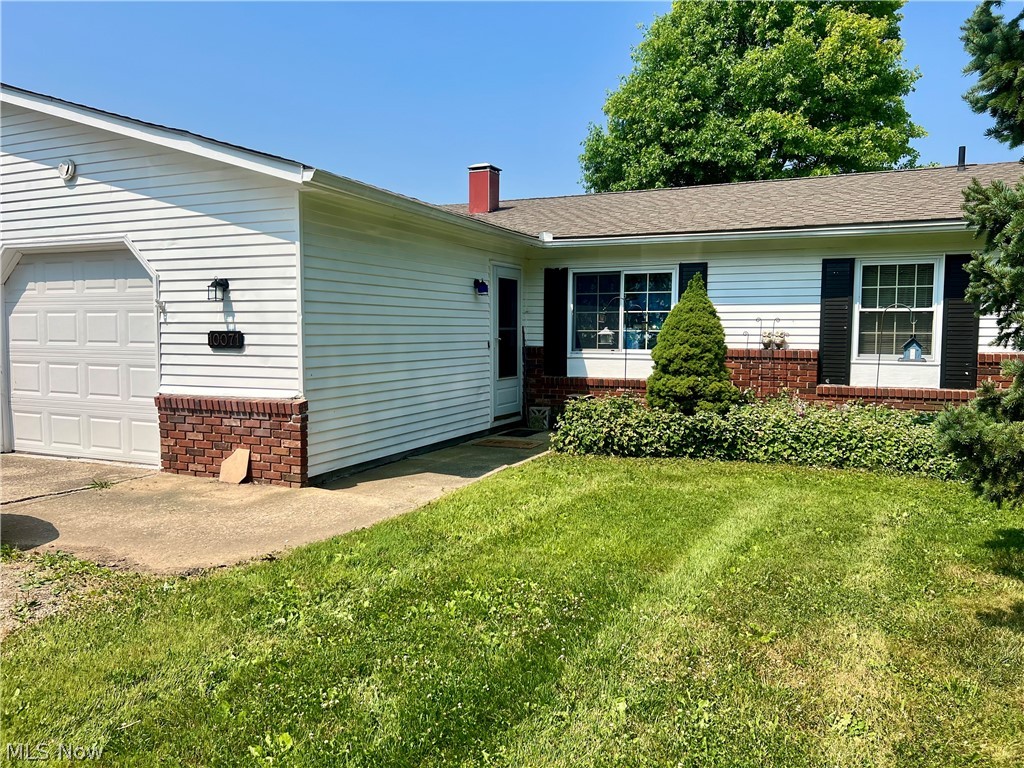 10071 Hazelton Road Streetsboro, OH 44241 - Photo 1 of 16 View of front facade with a garage and a front lawn