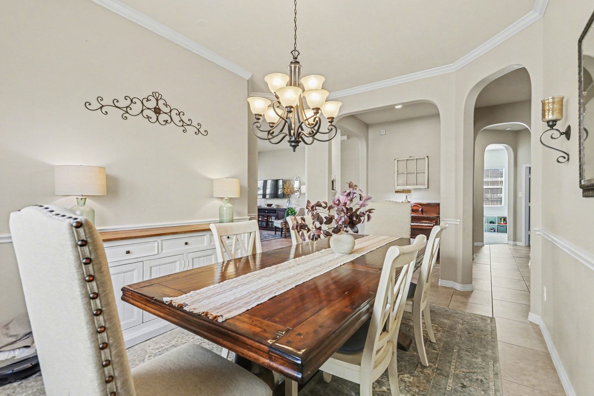 27006 Cliff Pointe Lane Katy, TX 77494 - Photo 10 of 34 Well-proportioned dining space with chair rail detailing and abundant natural light, offering both charm and versatility for entertaining.