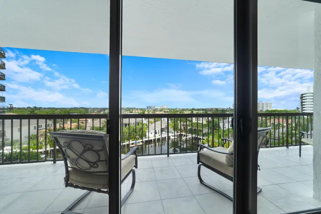 a large bedroom with a large bed and flat tv screen next to a large window