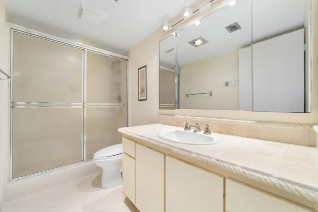 a spacious bedroom with a bed and a flat screen television