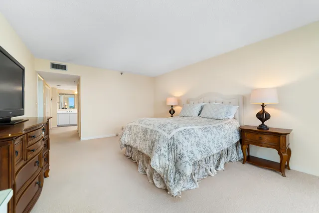 a spacious bathroom with a double vanity sink toilet and shower