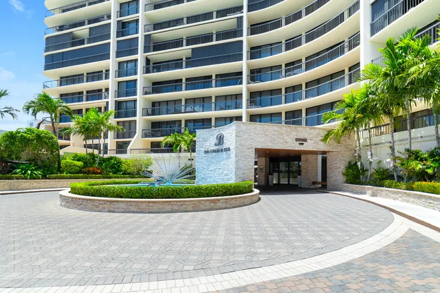 a front view of a multi story building with yard