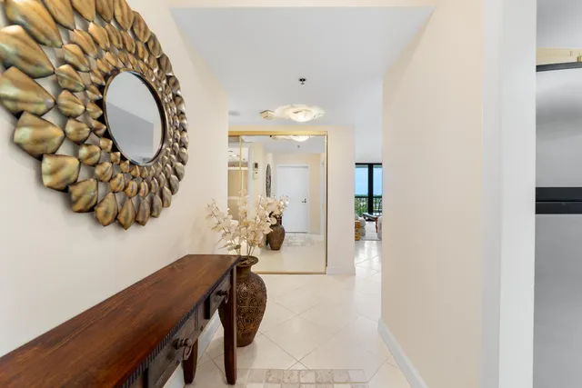 a view of a hallway with dining area and chandelier