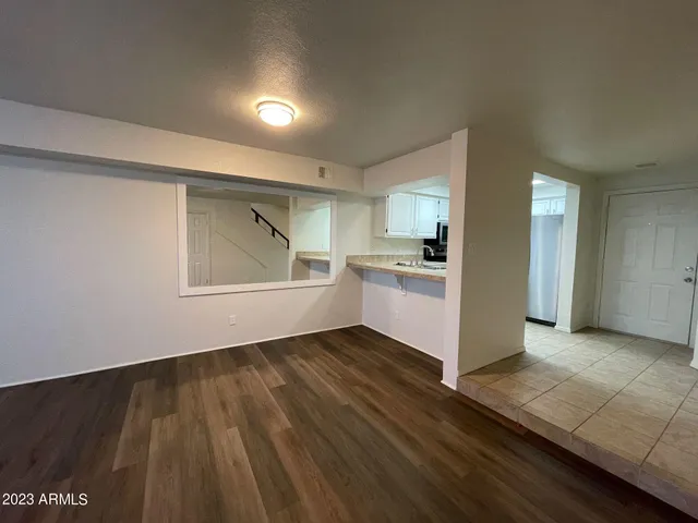 a view of a kitchen with wooden floor and electronic appliances