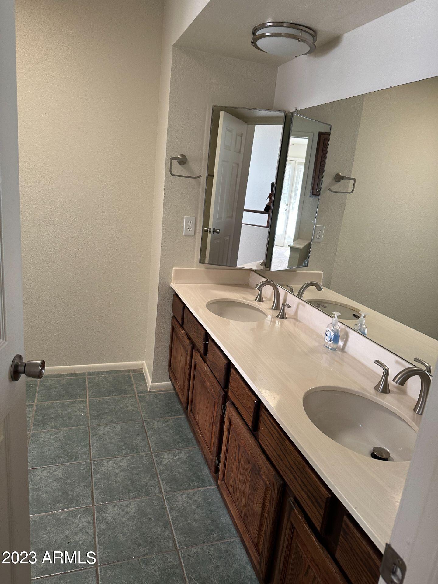 2121 West Union Hills Drive, Unit 108 Phoenix, AZ 85027 - Photo 15 of 35 a bathroom with a sink a vanity and a mirror