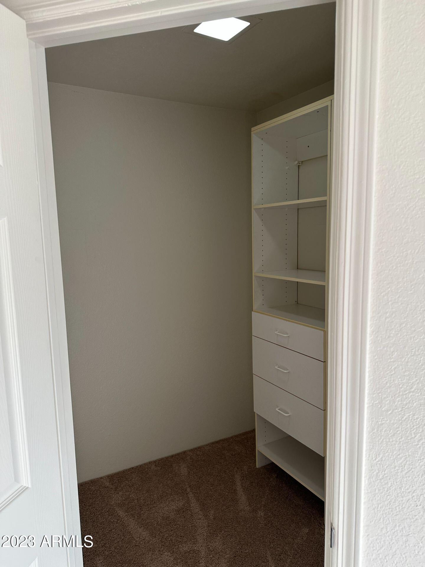 2121 West Union Hills Drive, Unit 108 Phoenix, AZ 85027 - Photo 18 of 35 a view of an empty walk in closet