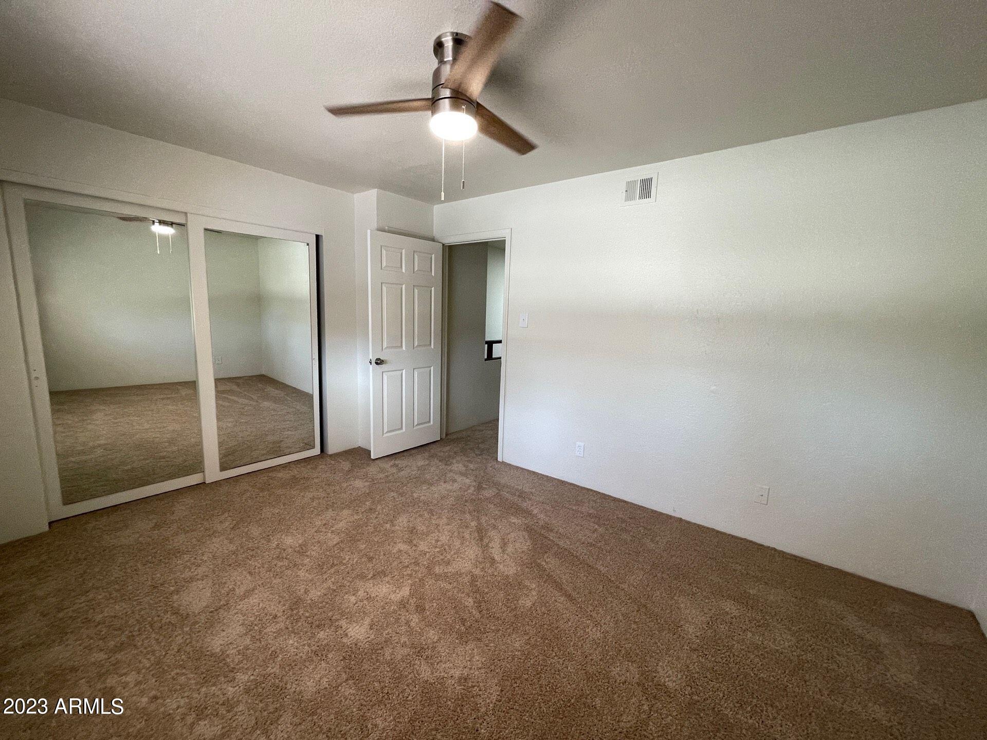 2121 West Union Hills Drive, Unit 108 Phoenix, AZ 85027 - Photo 25 of 35 an empty room with fan