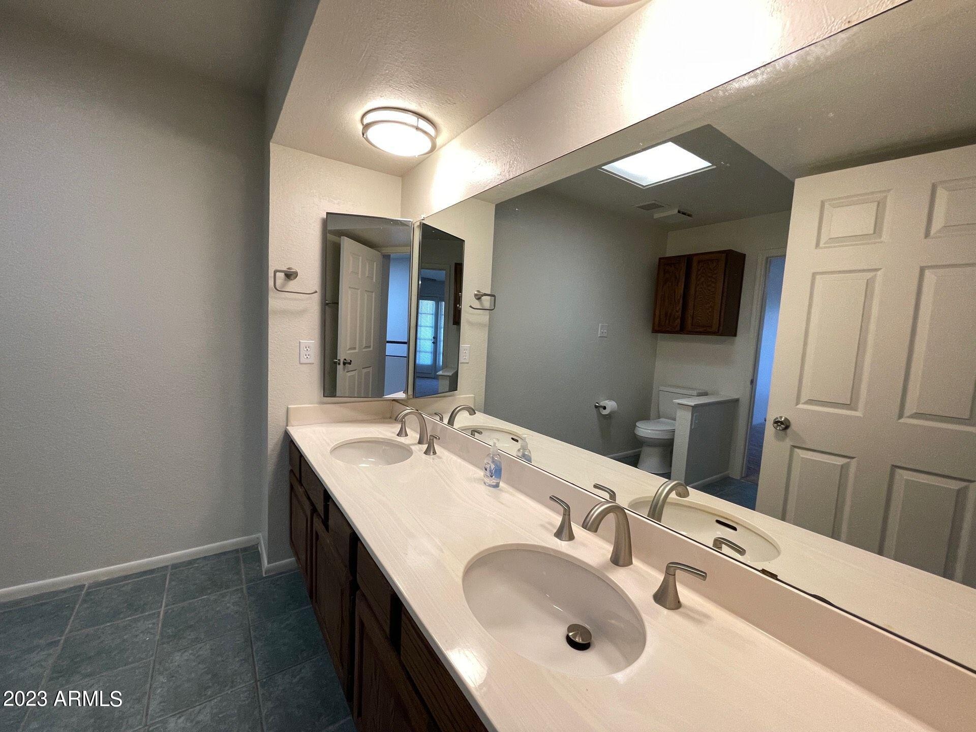 2121 West Union Hills Drive, Unit 108 Phoenix, AZ 85027 - Photo 27 of 35 a bathroom with a sink and a mirror