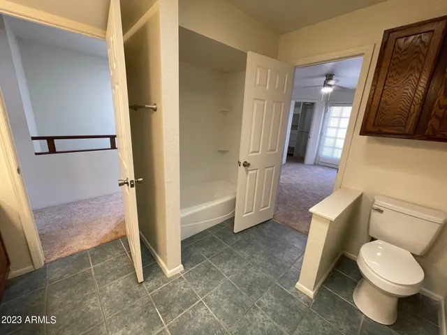 an empty room with an entrance and mirror