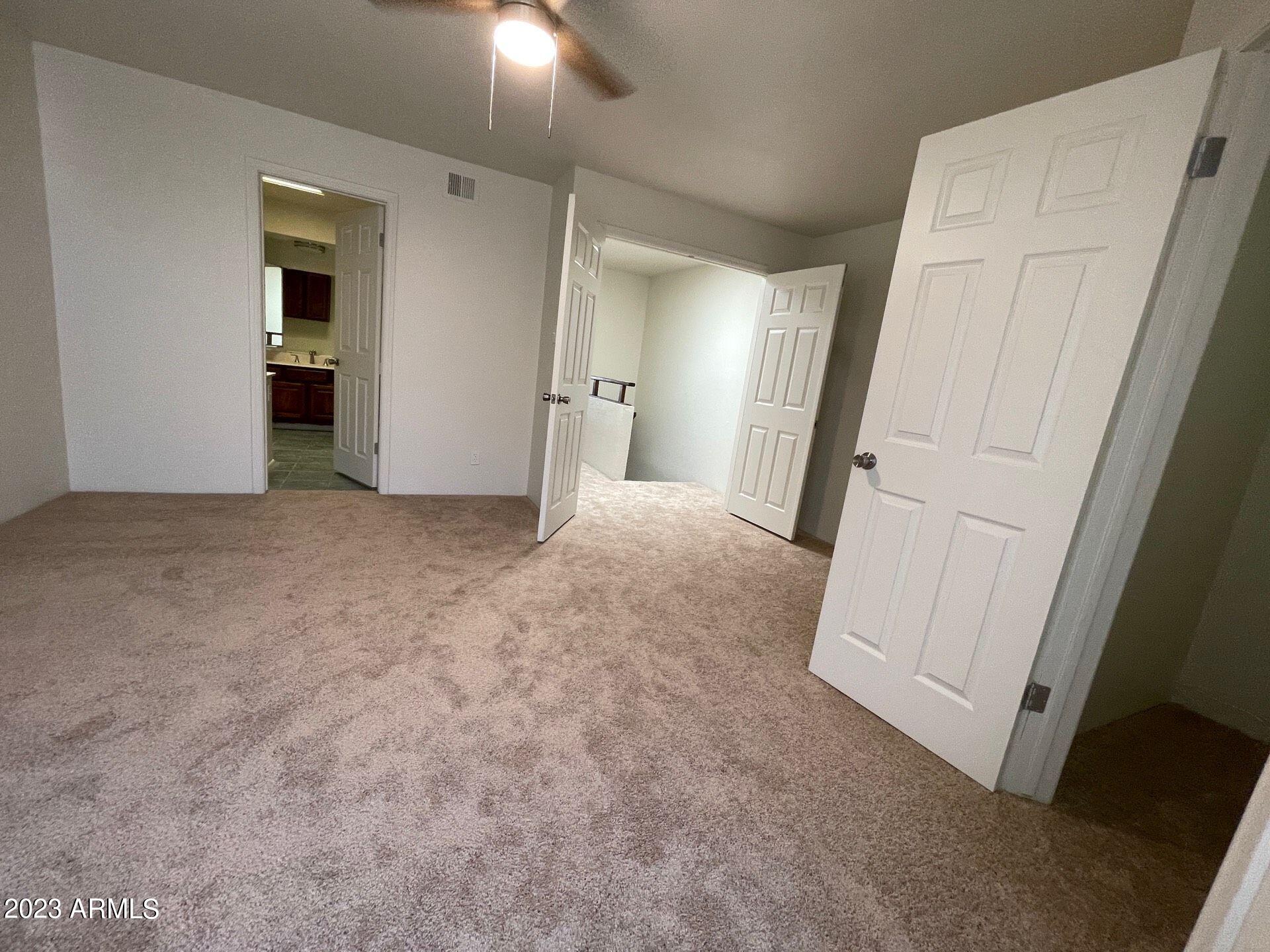 2121 West Union Hills Drive, Unit 108 Phoenix, AZ 85027 - Photo 33 of 35 an empty room with an entrance and mirror