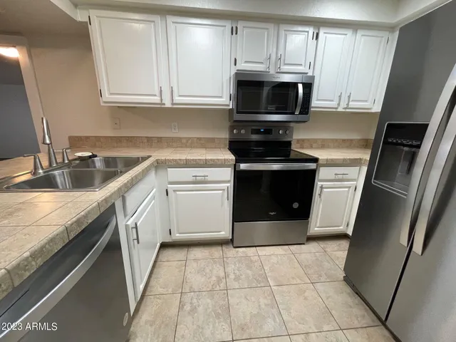 a kitchen with a sink stove and microwave