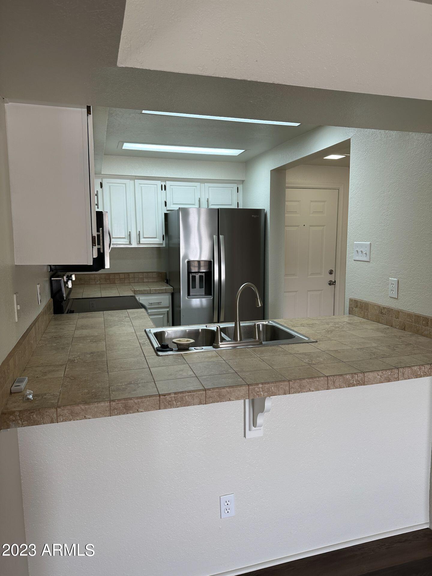 2121 West Union Hills Drive, Unit 108 Phoenix, AZ 85027 - Photo 8 of 35 a view of a hall with wooden floor