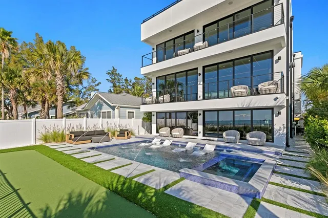 a front view of a house with garden and sitting area